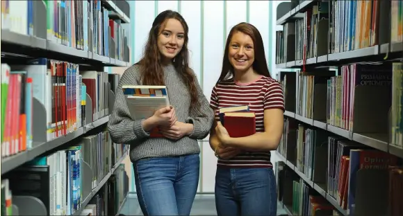  ?? Picture: Colin Mearns ?? Leah Wright, left, and Abbie Fenton both age 17 pictured in the library at Glasgow Caledonian University (GCU) where they are studying Advanced Highers.