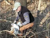  ??  ?? Troy Mayor Patrick Madden helps collect trash from the Tomhannock Reservoir on Saturday.