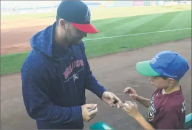  ?? David Borges / Hearst Connecticu­t Media ?? Milford’s Joe Zanghi, a reliever for Double-A Binghamton, signs an autograph for a young fan during the Rumble Ponies’ visit to Dunkin’ Donuts Park this past week.