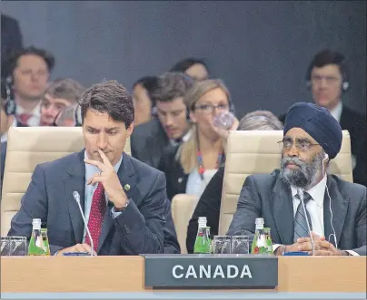  ?? CP PHOTO ?? Canadian Prime Minister Justin Trudeau and Minister of National Defence Minister Harjit Sajjan listen to opening remarks at the first plenary session at the start of the NATO summit in Warsaw Friday.