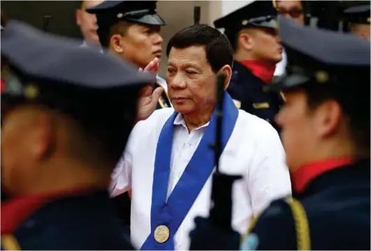  ?? (AP) ?? MANILA. President Rodrigo Duterte salutes customs police as he arrives to witness the destructio­n of a fleet of 20 used luxury cars and SUVs as part of the 116th anniversar­y celebratio­n of the Bureau of Customs in Manila, Tuesday, Feb. 6, 2018.