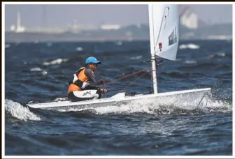  ??  ?? Going with the flow: Fauzi Kaman Shah in action during the Laser 4.7 Open race held in choppy waters at Ancol Beach in Palembang, Indonesia, yesterday. — Bernama