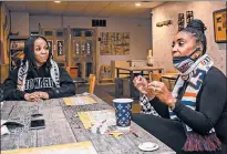  ?? MICHAEL GARD/POST-TRIBUNE ?? Chelsea Whittingto­n, left, of Gary, and Vikki Walton, of Merrillvil­le, discuss a fellow Howard University graduate, Vice President-elect Kamala Harris, over coffee at J’s Breakfast Club on Friday in Gary.