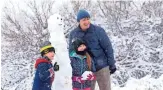  ?? ROB SCHUMACHER/THE REPUBLIC ?? The Sykes family poses with their snowman during a winter storm in Scottsdale on Tuesday. More storms are expected Friday.