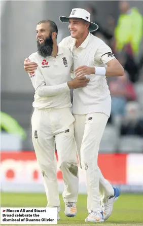  ??  ?? > Moeen Ali and Stuart Broad celebrate the dismissal of Duanne Olivier