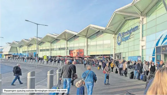  ?? ?? Passengers queuing outside Birmingham Airport this week