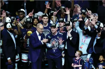  ?? ROSS D. FRANKLIN — THE ASSOCIATED PRESS ?? Uconn head coach Dan Hurley, center, and his players celebrate after the NCAA college Final Four championsh­ip basketball game against Purdue, Monday, April 8, 2024, in Glendale, Ariz.