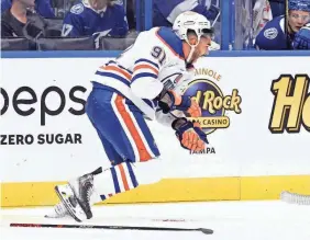  ?? JASON BEHNKEN/AP ?? Edmonton forward Evander Kane heads to the bench after being cut by a skate blade during the second period against Tampa Bay.