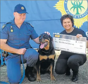 ?? Picture: BRIAN WITBOOI ?? GIVING, WITH LOVE: Sergeant Shaun Dicks with his dog, Bruno, and Animal Anti-Cruelty League inspector Beverley Rademeyer who received a cheque of R10 000