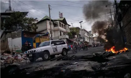  ?? Photograph: Ricardo Arduengo/AFP/Getty Images ?? A UN vehicle drives past a barricade of burning tires during a demonstrat­ion against high prices and fuel shortages in Port-au-Prince, Haiti, on Thursday.