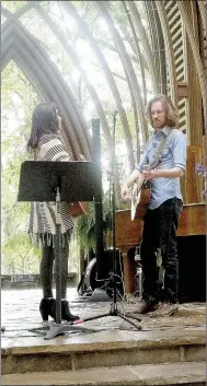  ?? Lynn Atkins/The Weekly Vista ?? Miranda and Chris Hawks warm up in the Mildred Cooper Chapel before a program featuring song writers brought together by the House of Songs in Austin to complete some of the unfinished work of Albert Brumley. The I’ll Fly Away Foundation sponsored the...