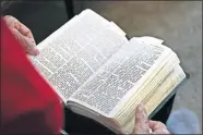  ?? ASSOCIATED PRESS] ?? Hannah Carson reads from the third chapter of Ecclesiast­es on Friday inside her Charlotte, N.C., apartment. At 90 years old, Carson reads her Bible daily, particular­ly her favorite verse detailing the different seasons of life. As soon as she received her absentee ballot in the mail six weeks ago, she filled it out and sent it back to her local election office. [SARAH BLAKE MORGAN/ THE