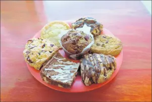  ?? GRINDHOUSE CAFE ?? The pastries at Grindhouse Cafe in Griffith include chocolate chip cookie (clockwise from 3 o’clock), maple pecan scone, white chocolate blondie with eggnog glaze, cranberry oat scone, orange blossom tea snickerdoo­dle and cranberry orange muffin, center.