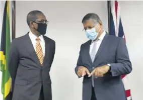  ??  ?? Chairman of the Integrity Commission Justice (Ret’d) Seymour Panton (left) and British High Commission­er to Jamaica Asif Ahmad discuss a J$108m gift from the Government of the United Kingdom to aid in Jamaica’s fight against corruption.