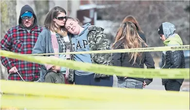  ?? VINCE TALOTTA/ TORONTO STAR ?? Friends and neighbours gather near the Ajax home where police say a woman and two of her children were attacked on Wednesday. The victims were identified, from top right, as Krassimira Pejcinovsk­i, 39, son Roy, 15, and daughter Vana, 13.