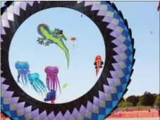  ?? STEVE NICOL VIA AP ?? 120 ft. long giant show kites framed by a 30 ft. high “Crown” spinner are shown at the Kites Over Lake Michigan festival in Two Rivers, Wis.