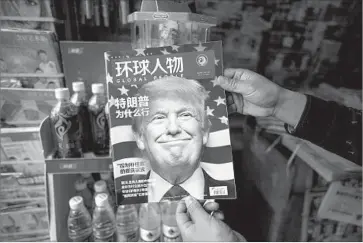  ?? Johannes Eisele AFP/Getty Images ?? THE CHINESE magazine Global People, sold at a Shanghai newsstand, features an article that asks “Why did Trump win?” No president or president-elect is believed to have spoken with a Taiwanese leader since 1979.