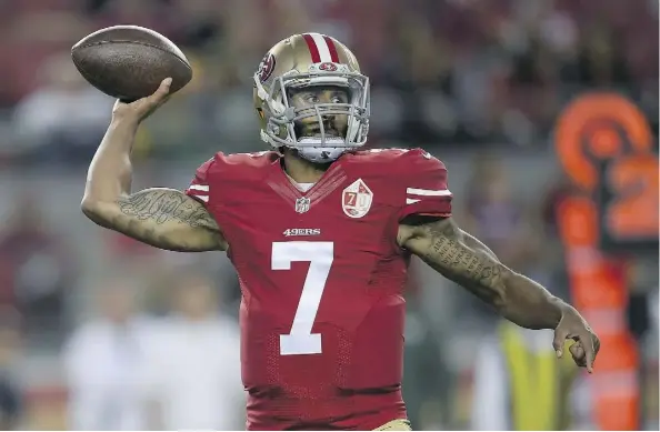  ?? THEARON W. HENDERSON/GETTY IMAGES ?? San Francisco 49ers quarterbac­ks Colin Kaepernick, left, drew some ire on social media for purposely sitting down during the playing of the national anthem prior to Friday’s 21-10 pre-season loss against the Green Bay Packers.