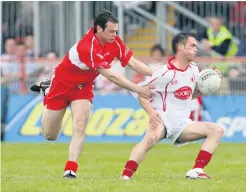  ??  ?? Pressure point: Paul Mcflynn (left), in action in 2006, believes Derry will feel the heat when inter-county fixtures resume