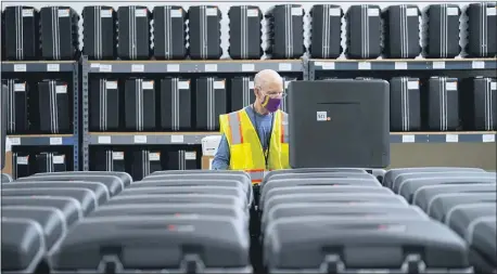  ?? GERRY BROOME — THE ASSOCIATED PRESS ?? A worker prepares tabulators for the upcoming election at the Wake County Board of Elections in Raleigh, N.C., on Sept. 3. A requiremen­t in some states that a witness or notary public sign a ballot envelope is a problemfor some voters.