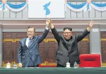  ?? Pool / Getty Images ?? North Korea’s Kim Jong Un (right) and South Korean President Moon Jae-in gesture Wednesday at a sports event in Pyongyang.