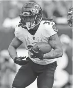  ?? AARON DOSTER/AP ?? Ravens running back Devonta Freeman carries against the Bengals on Sunday.