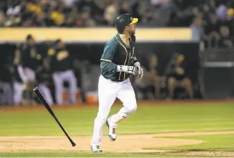  ?? Ezra Shaw / Getty Images ?? The A’s Trevor Plouffe follows the flight of his three-run homer in the seventh inning.