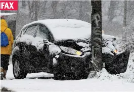  ??  ?? HALIFAX
Trunk road: This car hit a pole in heavy snow in a nearby village