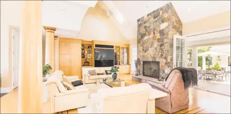  ?? Photos by Real Living Wareck D’Ostilio ?? Above: The living room at 50 Eveningsid­e Drive in Milford features a cathedral ceiling with skylights, a soaring stone fireplace and custom bird’s eye maple cabinetry with a built- in wet bar and entertainm­ent center. Below: The home is on .49 acres set high on a bluff.