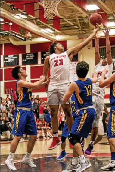  ?? NATE HECKENBERG­ER — FOR DIGITAL FIRST MEDIA ?? Coatesvill­e Tione Holmes corrals a rebound in the second quarter during Tuesday’s District 1 Class 6A playoff game against Downingtow­n East.