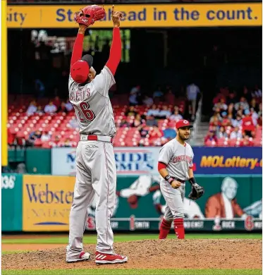  ?? DILIP VISHWANAT / GETTY IMAGES ?? Reds reliever Raisel Iglesias celebrates after Cincinnati beat the Cardinals at Busch Stadium on Sunday. Iglesias pitched two innings to record his fourth save in as many chances.