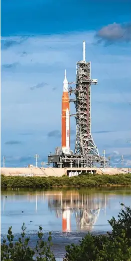  ?? JOE BURBANK/ORLANDO SENTINEL ?? Artemis I, NASA’s Space Launch System heavy-lift rocket carrying the Orion spacecraft, sits on Launch Pad 39-B at Kennedy Space Center on Saturday. The launch of the unmanned test flight is scheduled for 8:33 a.m. Monday.