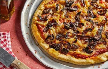  ?? Tom McCorkle/The Washington Post ?? Vegan Pizza With Miso-Caramelize­d Onions and Shiitake Bacon. Some meatless bacon is made from mushrooms, but it looks and cooks the most like bacon.