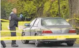  ?? MORNING CALL FILE PHOTO ?? An Allentown police officer photograph­s Charles Hughes III’s vehicle after he was shot dead last year. His shooter was convicted Friday.