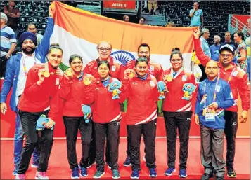  ??  ?? The Indian table tennis team celebrates on the podium after winning the gold on Sunday.