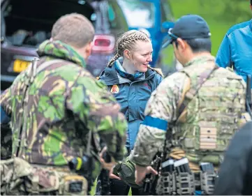  ?? ?? Top: The group who regularly meet to play airsoft in Fife.
Above: Maria receives some last-minute instructio­ns. Pictures by Steve Brown.