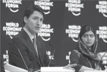  ?? PAUL CHIASSON, THE CANADIAN PRESS ?? Prime Minister Justin Trudeau, left, alongside Malala, told reporters in Davos that a NAFTA deal is “eminently possible.”
