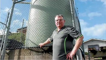  ??  ?? John Owens, with the tank he installed to provide fresh water for his customers in Kaeo.