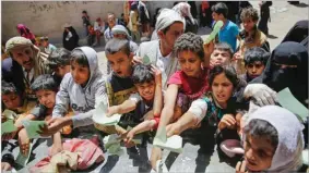  ??  ?? Yemenis present documents in order to receive food rations provided by a local charity in Sana’a, Yemen, on April, 13, 2017. AP