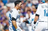  ?? Associated Press ?? Colorado Rockies’ Nolan Arenado, left, celebrates his three-run, walkoff home run with teammates in the ninth inning of Sunday’s game against the San Francisco Giants in Denver.