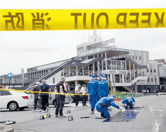  ?? Photo / Bloomberg via Getty Images ?? Police officers at the scene where former Japanese Prime Minister Shinzo Abe was shot during a political event in Nara, Japan.