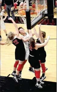  ?? MARK HUMPHREY ENTERPRISE-LEADER ?? Prairie Grove sophomore Trinity Dobbs draws a crowd and contact but no foul as three Pea Ridge defenders meet her after a drive to the hoop. Pea Ridge defeated the Lady Tigers, 48-26, in a Monday, Jan. 13, game reschedule­d due to a severe weather threat the previous Friday.