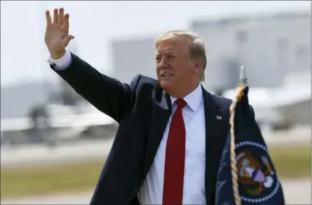  ?? SUSAN WALSH — THE ASSOCIATED PRESS ?? President Donald Trump waves to the crowd Wednesday after arriving on Air Force One at Louisville Internatio­nal Airport in Louisville, Ky. Trump is in town to speak at the American Veterans (AMVETS) 75th National Convention.