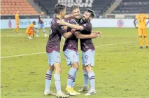  ?? Michael Wyke, The Associated Press ?? Rapids midfielder Cole Bassett, left, forward Diego Rubio, middle, and midfielder Jack Price ( 19) celebrate Rubio’s goal in the last minute Sunday in Houston.