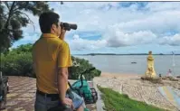  ?? HECTOR RETAMAL / AFP ?? A man in Xiamen, Fujian province, looks across the water to Jinmen, a county and small island attached to Taiwan, on Wednesday.