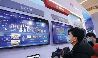  ?? PROVIDED TO CHINA DAILY ?? Visitors look at descriptio­ns of Huawei products during an expo in Beijing.