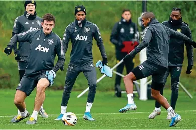  ?? PICTURE: PA ?? European challenge: Harry Maguire (left) and Ashley Young (right) battle for the ball in training