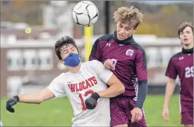  ?? James Franco / Special to the Times Union ?? Maple Hill senior Eli Charlebois, left, and Greenville junior Bernard Davis battle for position Saturday. The Spartans pulled away in the second half.