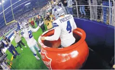  ?? RON JENKINS/ASSOCIATED PRESS ?? Dallas quarterbac­k Dak Prescott (4) celebrates his touchdown run with Ezekiel Elliott during the Cowboys’ win over the Redskins Thursday.