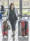  ?? POSTMEDIA ?? A woman walks through a nearly empty Ottawa airport.